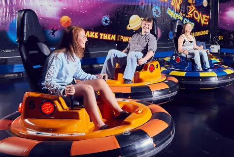 Teens playing on spinning bumper cars